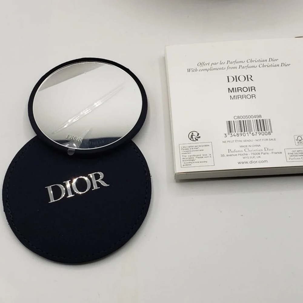 DIOR mirror with DIOR logo embossed on the front.